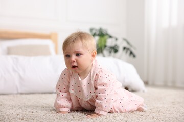 Cute little baby girl crying at home