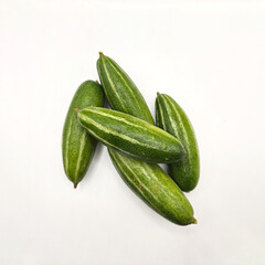 Potol or pointed gourd vegetable on isolated white background. Pointed gourds over white...
