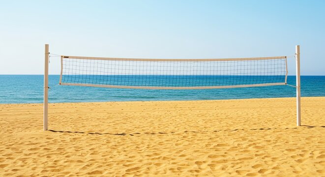 Beach volleyball net standing on a sandy beach with ocean and blue sky in background