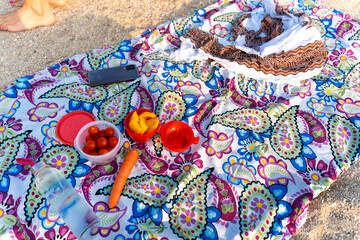 Fototapeta premium Beach towel picnic with fresh healthy food and mobile phone