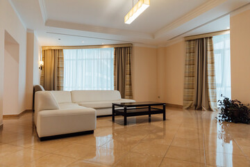 Interior of a living room with a sofa and windows