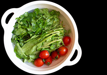 Fresh Harvest: Greens and Tomatoes Ready for Salad
