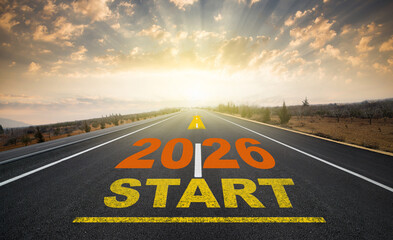 Concept for the start of the new year 2026. The word 2026 written on the asphalt road at sunrise....