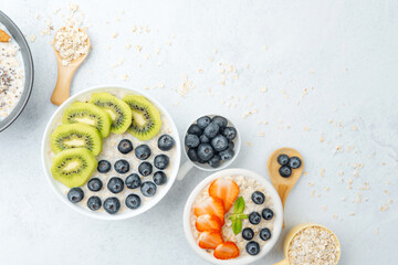 Oatmeal with strawberries and blueberries on white background