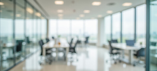 Fototapeta na wymiar Bright blurred office background with glass walls and desks in modern coworking space for business presentation or digital design use