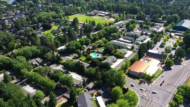 4K aerial drone video of a beautiful residential apartment complex in Cedar Mill, Portland, OR, captured at morning. Footage shows green courtyards, swimming pool, parking lots and housing buildings	