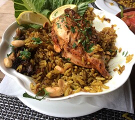 Traditional Middle Eastern Chicken and Rice Dish with Nuts and Herbs