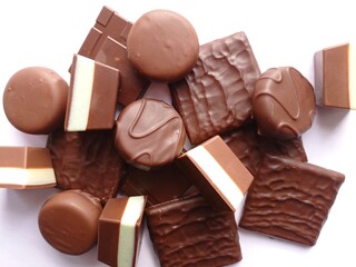 Top view of a pile of various chocolate candies.