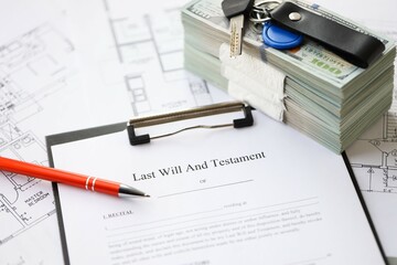 Pen and keys on Last will and testament form and planning blueprints of residential building project