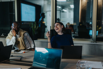 Business colleagues discussing ideas in a modern office at night