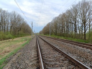 Two way railroad tracks in countryside. Two railway tracks. Cloudy day. Countryside. Fields and...