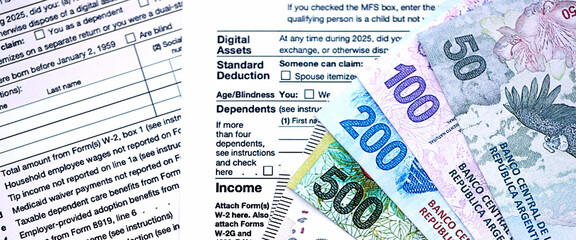 Argentine pesos money bills in big amount lies on table with pen and tax forms close up
