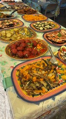 Variety of dishes and meals on plate on a table. Healthy food ready to eat in restaurant. Close up. Vertical.