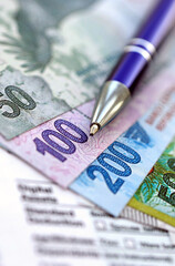 Argentine pesos money bills in big amount lies on table with pen and tax forms close up
