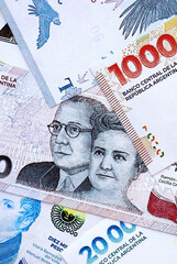 Argentine pesos money bills in big amount lies on white table close up