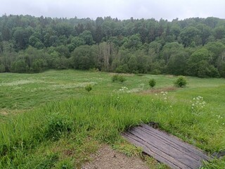 Bubiai hill during cloudy day. Small hill. Grass is growing on hill. Staircase leading to the top....