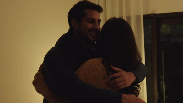 Loving couple hugging romantically together at home, happy in their relationship with deep affection and heartfelt reconciliation