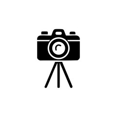 Black camera icon on tripod stand, symbolizing professional photography or media.

