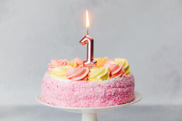 Celebrating a special birthday with a pink cake and a candle