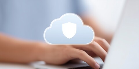 Hands typing on a laptop keyboard with a cloud security icon overlay, representing digital protection and data privacy in a modern technology environment