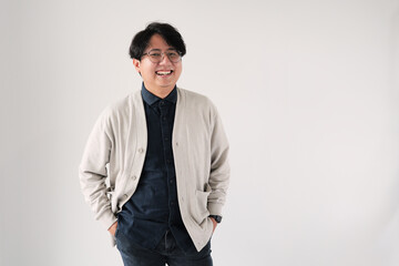 A man wearing glasses and a blue shirt is smiling