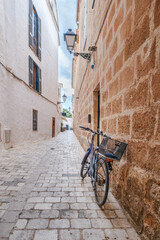 Quaint Cobblestone Alley In Ciutadella Old Town With A Bicycle And Traditional Architecture. Menorcan Street Scene, Spanish Island Life, Historic Charm