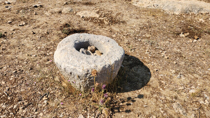 At Adamkayalar ancient settlement, this stone object is an ancient mortar (dibek), likely used for grinding grain. It offers a glimpse into Roman-era daily life.