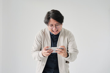 A man is playing a video game on a Nintendo Wii