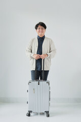 A man is standing in front of a suitcase