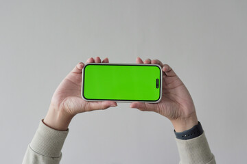 A person is holding a green iPhone