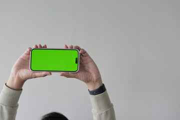 A person is holding a green phone