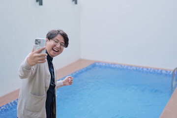 A man is taking a picture of himself in a pool