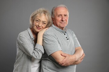 Portrait of lovely senior couple on grey background