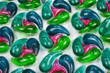 Full-frame, top-down shot showcases a vibrant, repeating pattern of colorful laundry detergent...