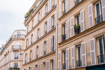 Row of Classic Parisian Apartment Buildings with White Shutters