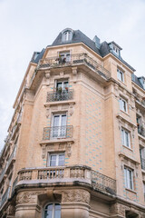 Corner of Elegant Parisian Apartment Building with Ornate Balconies and Brick Details