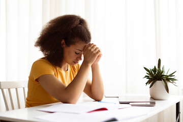 Working Stress. Portrait Of Upset Black Woman Sitting At Desk With Laptop, Tired After Work On Computer At Home, Depressed African American Lady Resting Forehead On Hands, Feeling Exhausted