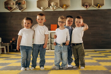In the kindergarten, standing and having fun. Group of children