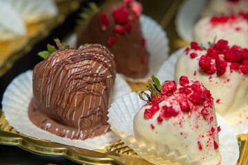Luxurious handmade decorative chocolates in a display case of assorted pralines with selective...
