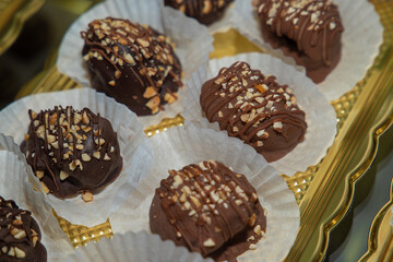 Luxurious handmade decorative chocolates in a display case of assorted pralines with selective...