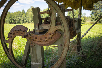 A rusty old machine with a green handle