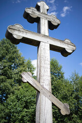 A wooden cross with three arms and a cross on top