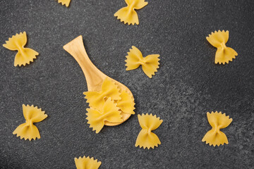 Decorative arrangement of pasta shapes on a dark kitchen surface