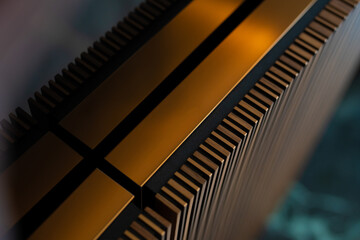 Close-up of Textured Metallic Surface with Grooves and Golden Accents