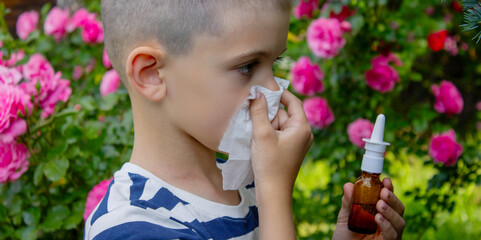 Child Sneezing from Flower Allergy. Selective focus