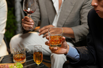 Closeup businessmen holding a glass of whiskey