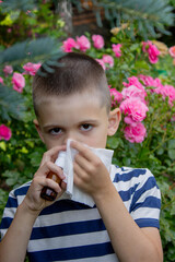 Child Sneezing from Flower Allergy. Selective focus