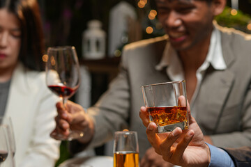 Closeup businessmen holding a glass of whiskey