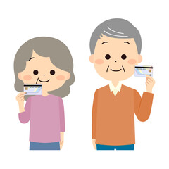 マイナンバーカードを手に持つシニアの男性と女性
