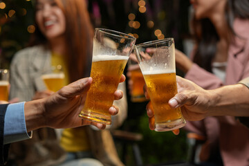 food and drink male friends are happy drinking beer and clinking glasses at a bar or pub.